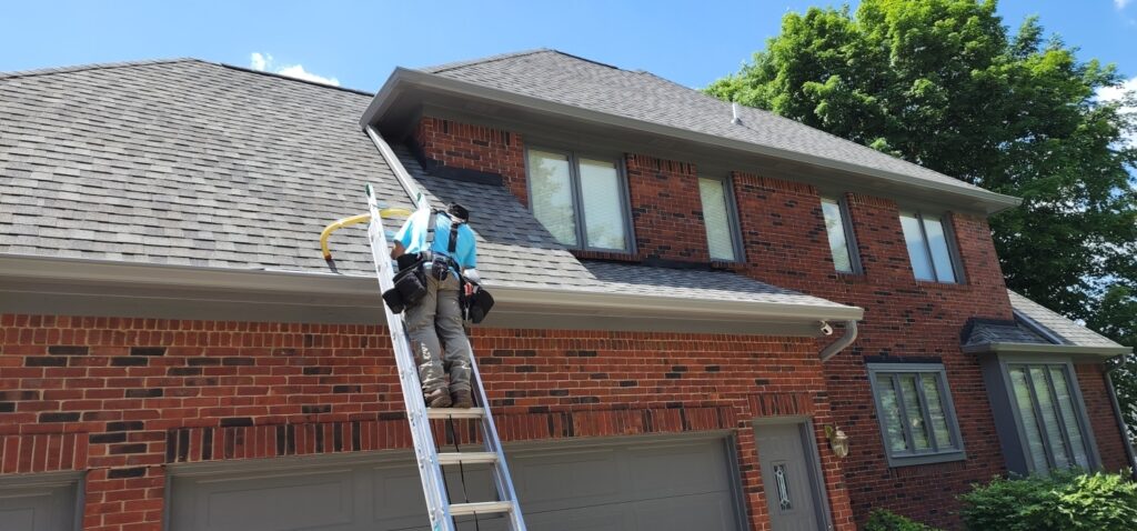 One of our employees repairing gutters on a